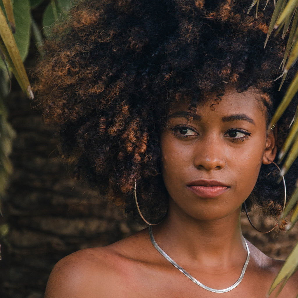Woman Wearing Hoop Earrings and Collar Necklace